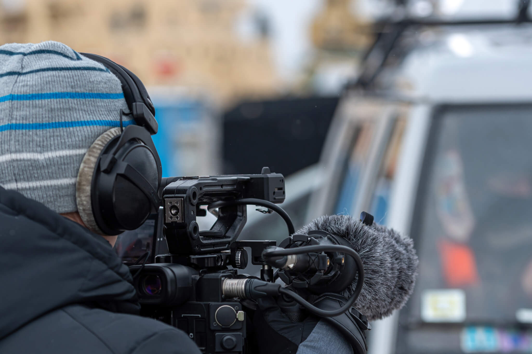 man-with-video-camera-reporter-cameraman-videographer-outdoor.jpg