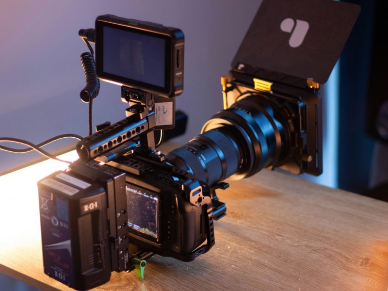 black dslr camera on brown wooden table